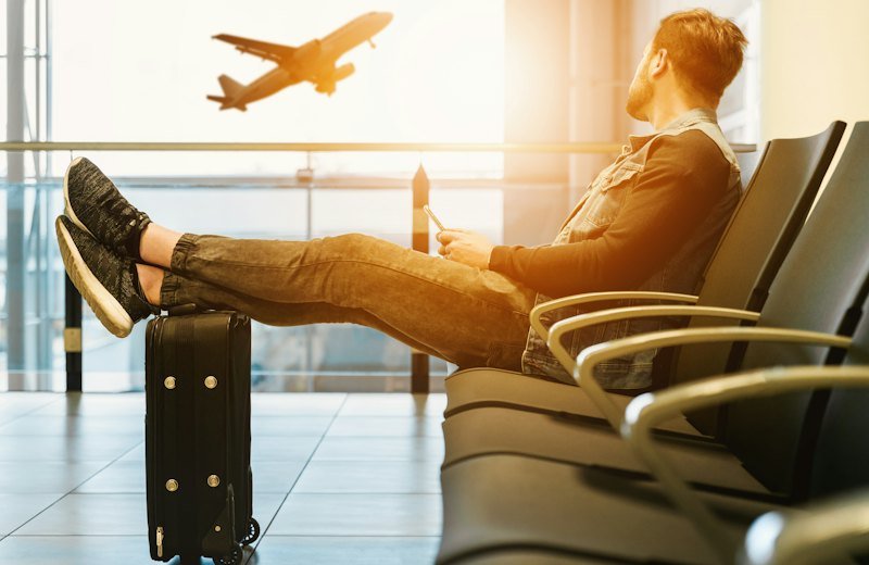 Traveller with luggage waiting at an airport gate